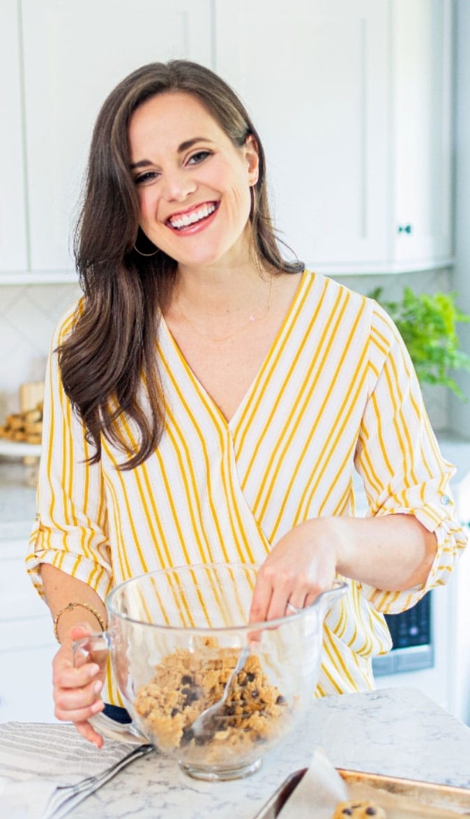 Noelle Tarr, founder of Well Minerals natural vitamins and supplements, smiles and mixes cookie dough in a large bowl